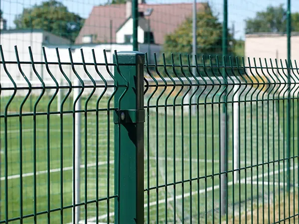 Green V-bend mesh panels connected to a profiled fence post
